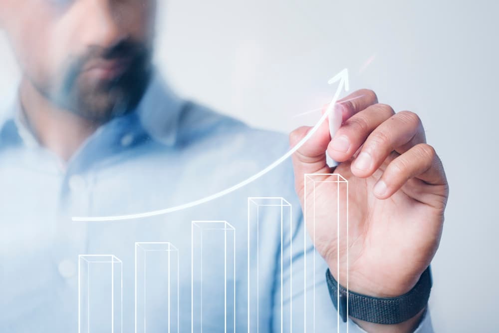 Man giving a presentation with a digital pen and representing scalability as one of the benefits of managed it services. 