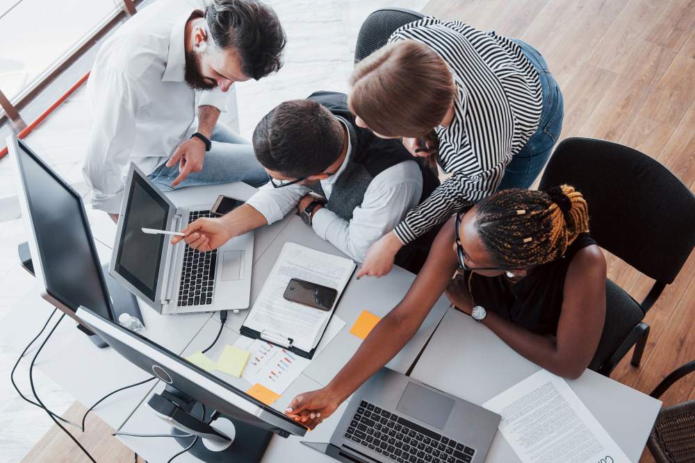 Team of IT professionals analyzing the benefits of managed IT services. 